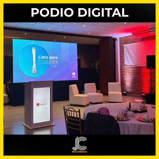 Un salon de evento donde esta instalada una pantalla LED, unos sillones, y un podio con pantalla LED en la parte frontal.